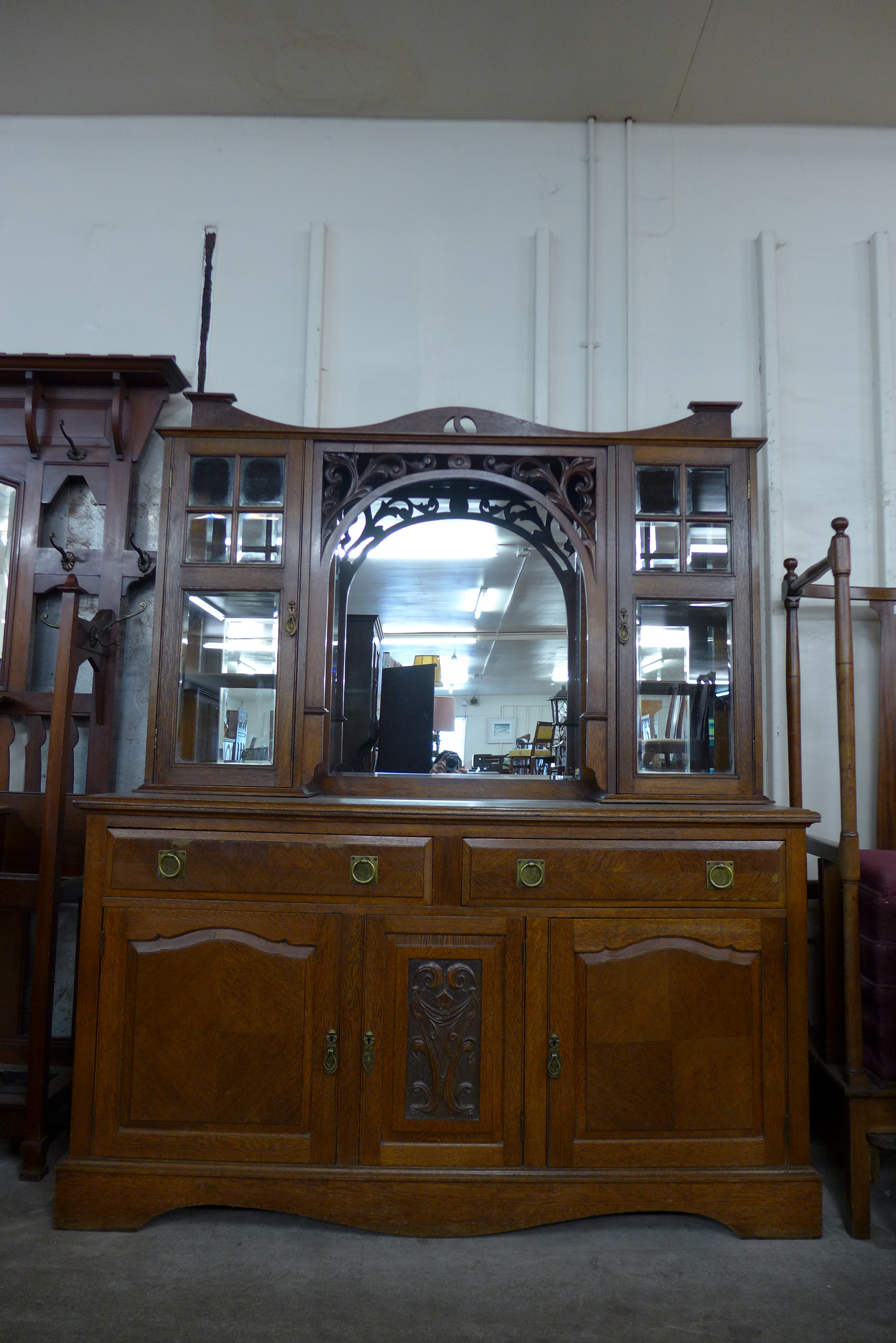 An Arts and Crafts oak mirrorback sideboard