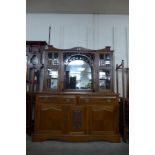 An Arts and Crafts oak mirrorback sideboard