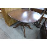 An Ercol extending pedestal dining table