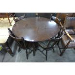 A beech circular dining table and four chairs