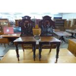 A pair of Victorian mahogany shield back hall chairs