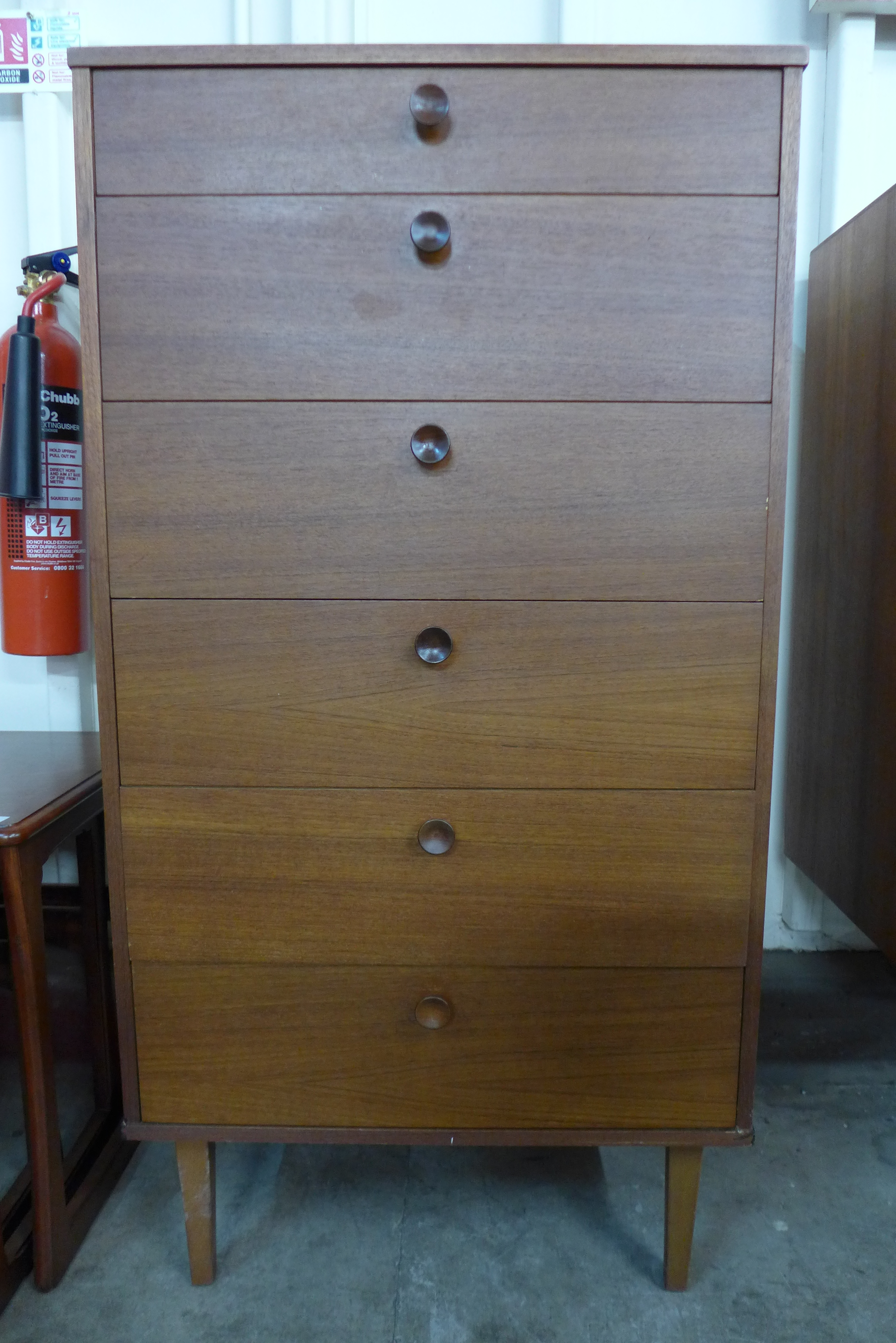 A teak chest of drawers