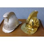 A replica brass fire brigade helmet and a papier mache helmet