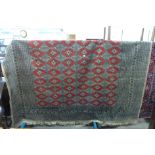 A large beige and red ground rug, a/f, approx.