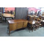 A walnut and mahogany eight piece dining suite