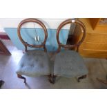 A pair of Victorian walnut balloon back dining chairs