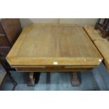 An oak draw-leaf dining table