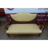 A Victorian Aesthetic Movement carved walnut and upholstered settee