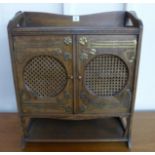 An Arts and Crafts oak and brass mounted table top cabinet