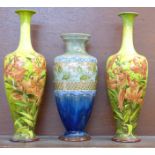 A pair of Royal Doulton floral decorated vases and a Doulton Lambeth vase, a/f,