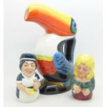 A Guinness toucan ceramic jug and two Royal Doulton candle snuffers