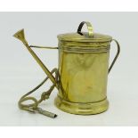 A novelty brass money box in the form of a watering can