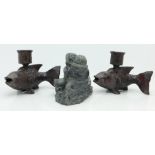 An Inuit carving and a pair of cast metal fish candlesticks