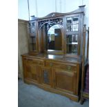 An Arts and Crafts oak mirrorback sideboard