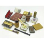 A collection of sixteen Tobacciana items including vesta cases, pipes, a gold banded cheroot holder,