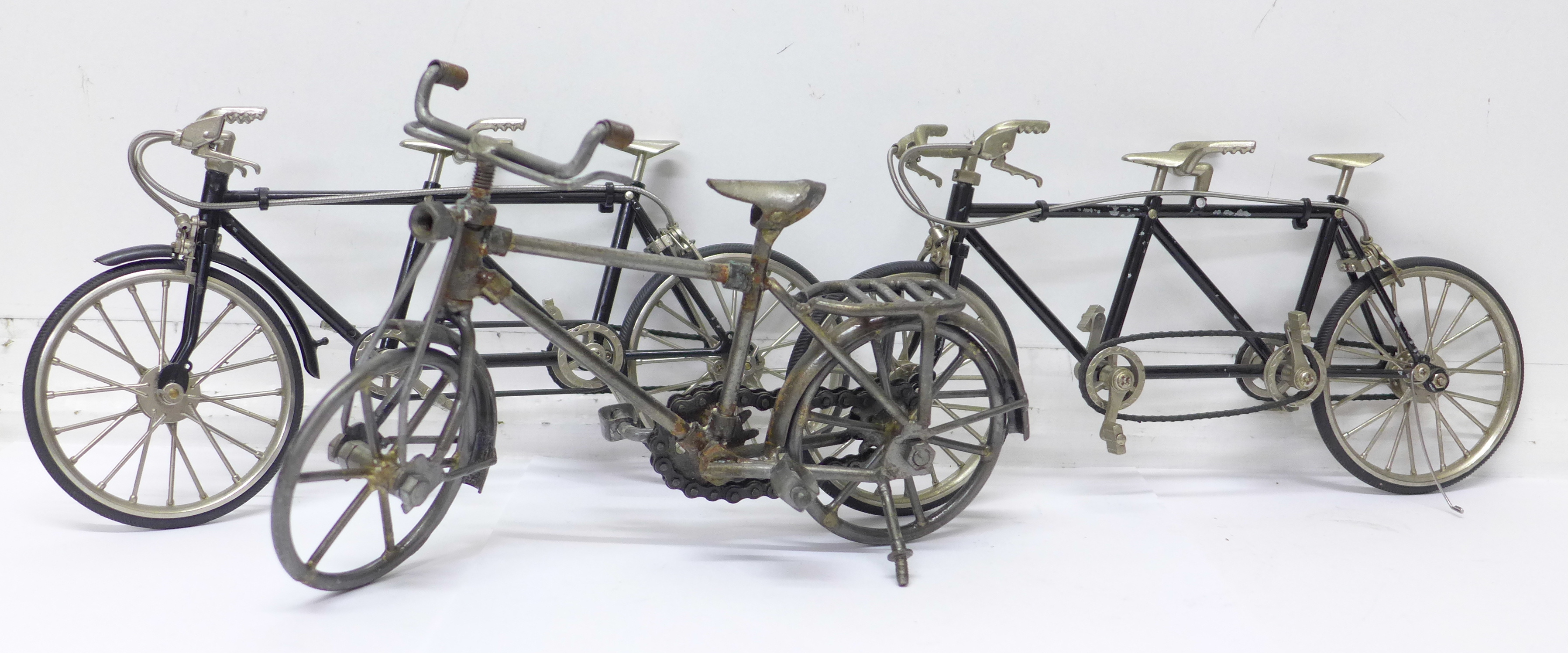 Two model tandem bicycles and one other model bicycle,