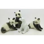 Three Russian panda figures and a figure of a polar bear