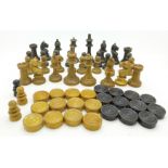 A set of chess pieces and some draughts pieces