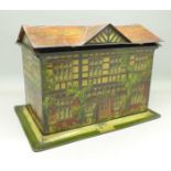 A tin in the form of a house, no visible name,
