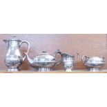 A three piece electro plate Britannia Metal tea service and a James Dixon plated water jug