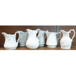 Six Portmeirion parian ware relief moulded jugs