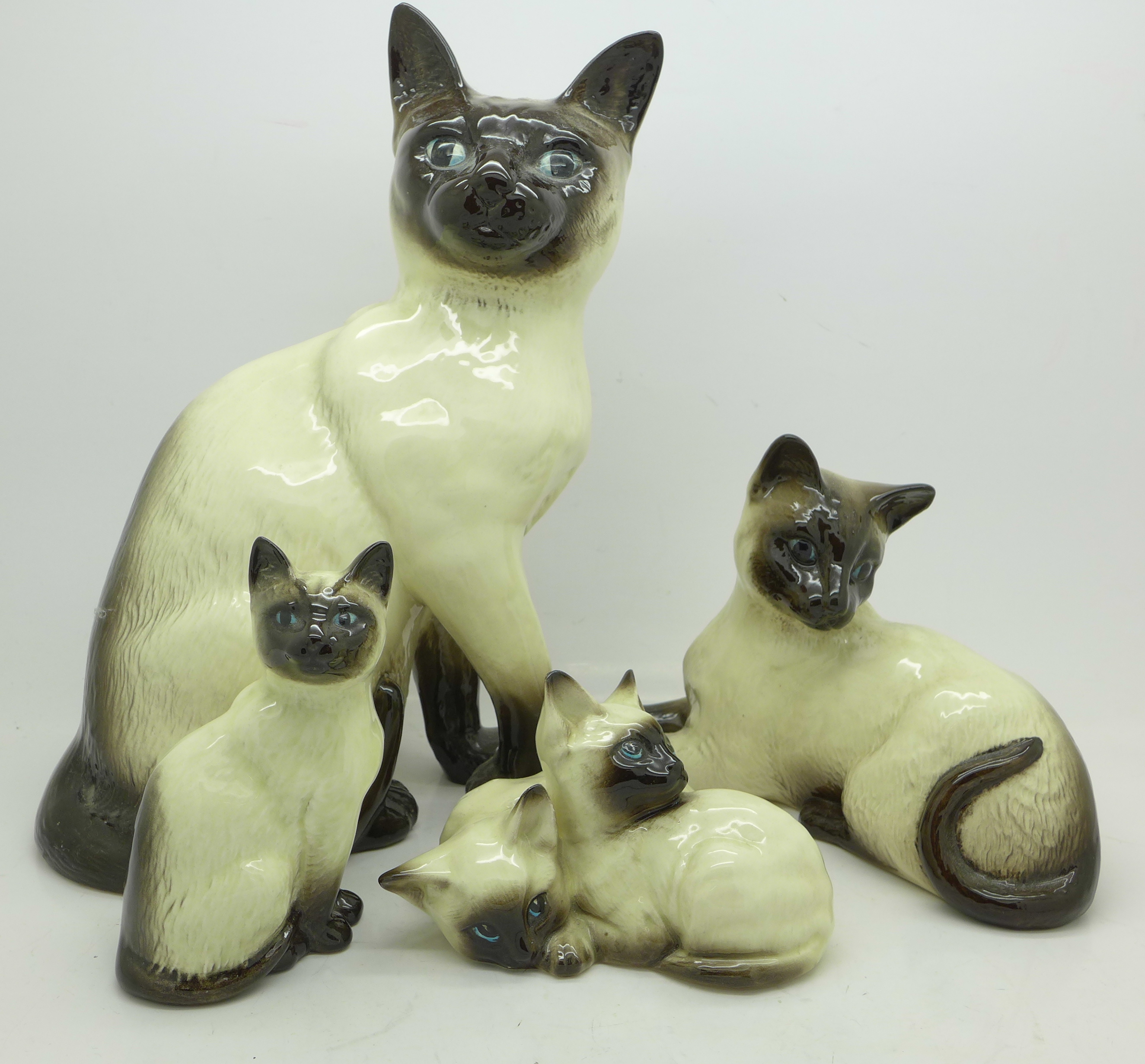Three Beswick Cat figures and a Beswick cat group figure,