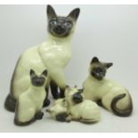 Three Beswick Cat figures and a Beswick cat group figure,