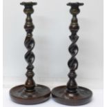 A pair of oak barleytwist candlesticks