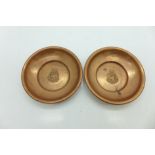 Two small copper dishes, HMS Resolution motif to each centre,