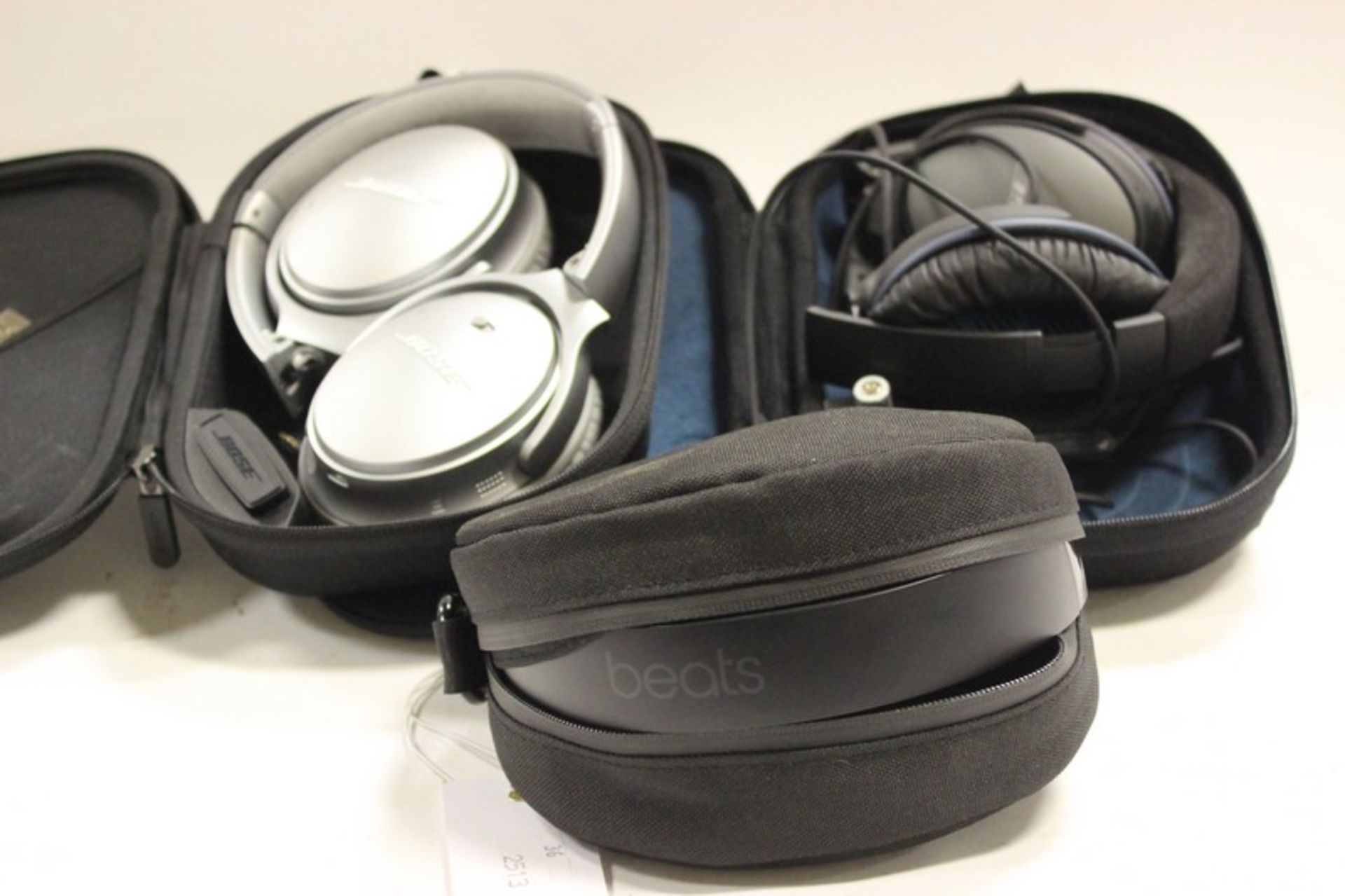 A pair of Bose QC25 in case, pair of Bose QC35 in case and a pair of Beats A1796 serial: