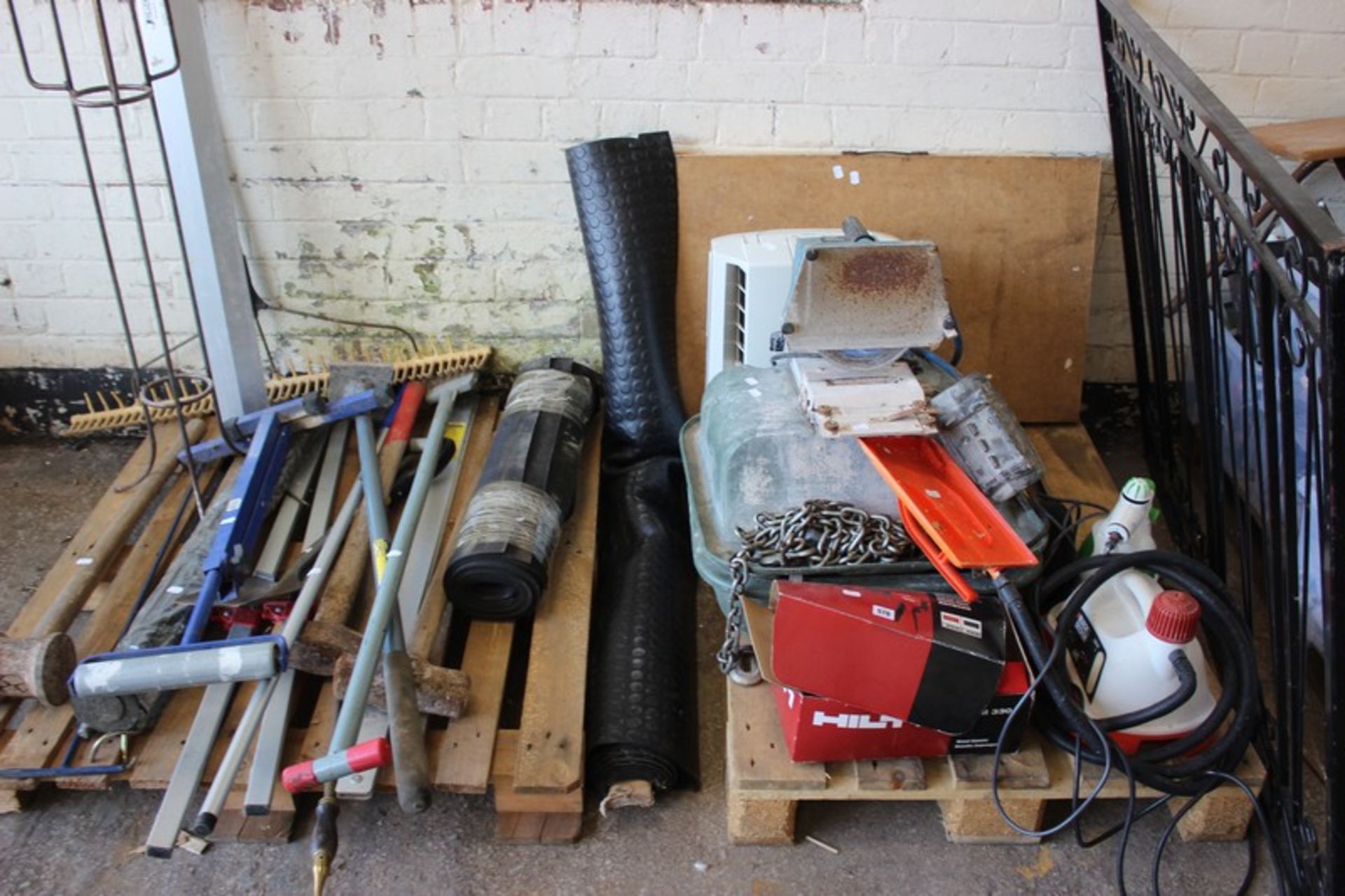 A Hilti HDM 330 manual dispenser, Black & Decker steamer, pasting table, assorted garden tools and
