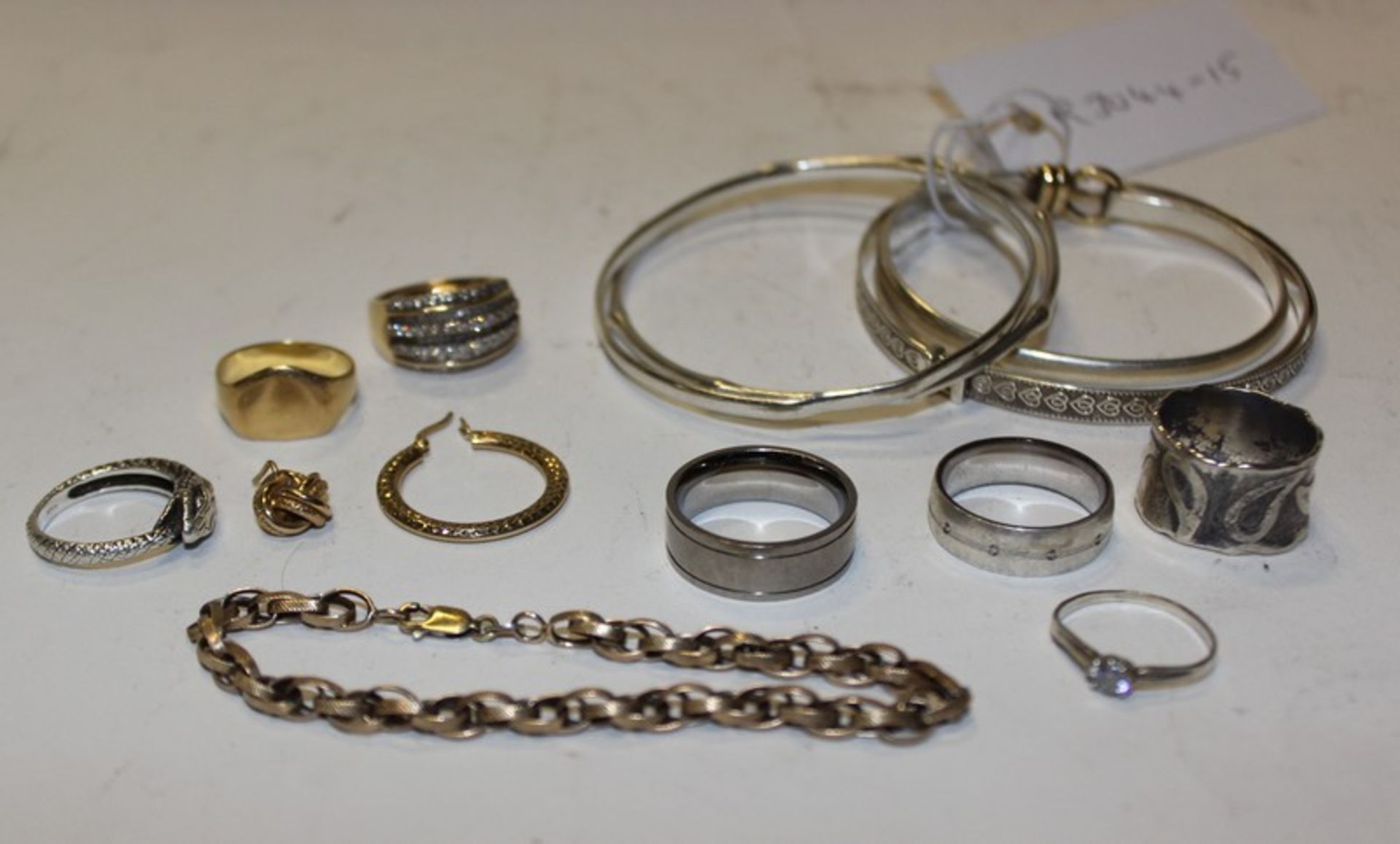 A collection of jewellery to include five silver bangles, six rings and other items.