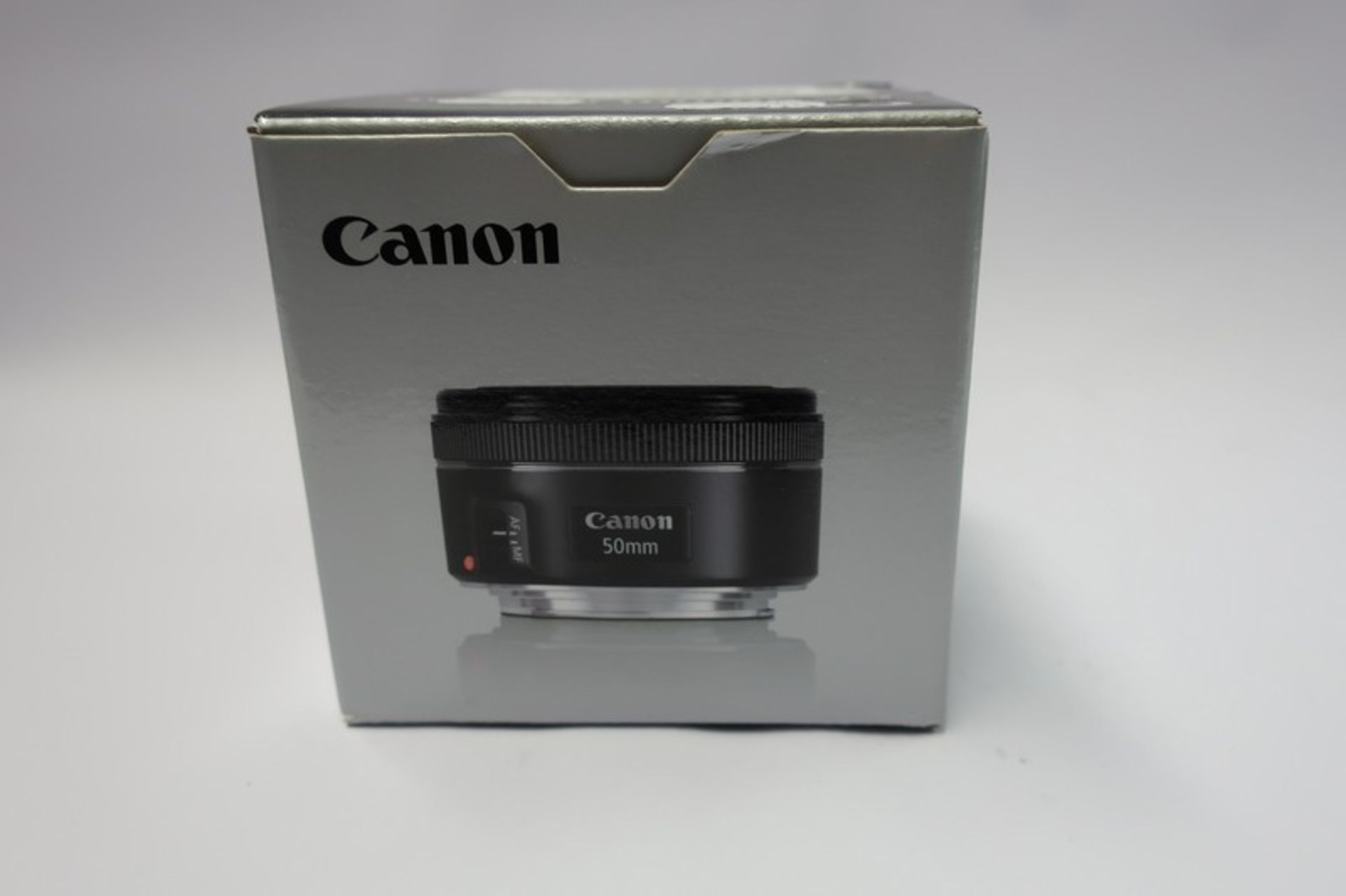 A boxed as new Canon EF 50mm f/1.8 STM lens.