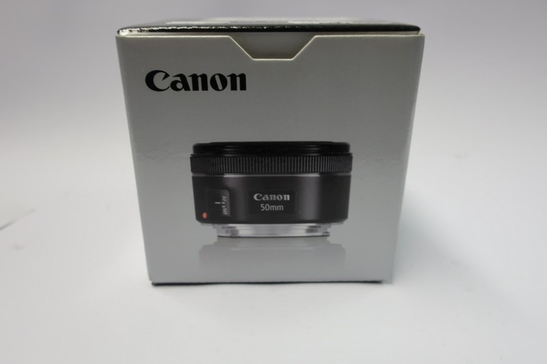 A boxed as new Canon EF 50mm f/1.8 STM lens.