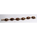 A 9ct gold link bracelet with tiger's eye stones of ovoid form 19cmL