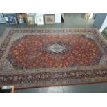 A large West Persian rug with central lozenge on a red and blue ground 491 x 306cm