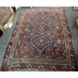 A large Afghan rug on a brown ground 240 x 185