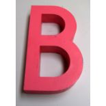 A pink painted metal letter 'B',