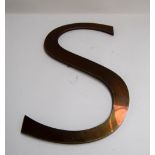 A polished metal letter 'S',