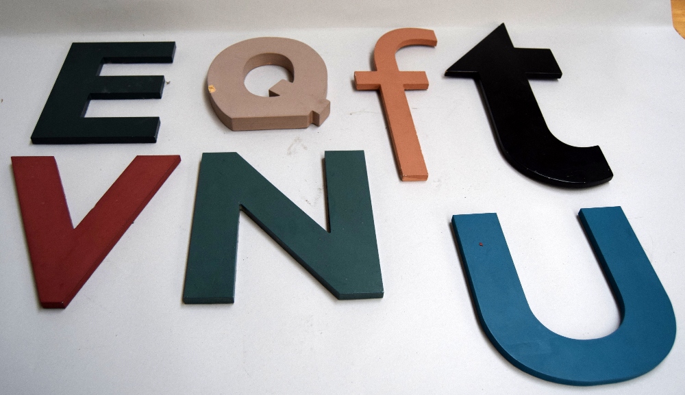 The letters E, F, N, Q, T, U, V, laser cut from wood and painted,