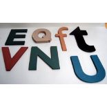 The letters E, F, N, Q, T, U, V, laser cut from wood and painted,