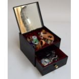 A jewellery box filled with costume jewellery including rings,