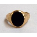 A 9ct gold signet ring with black onyx stone inset, size O, net weight 7.