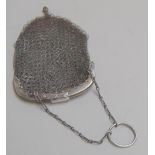 A small ladies chain mail coin purse with clasp closure on small chain