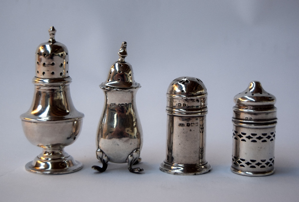 A selection of four sterling silver pepper and salt shakers,