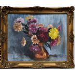 A framed still life of flowers signed M.