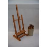 A wooden portable easel together with an earthenware cider jug