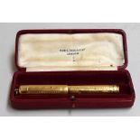 A gold pump action fountain pen made by Mabie Todd and Co.