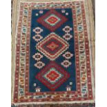 A brightly coloured Persian rug with three central lozenges 150 x 110cm