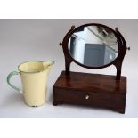 A small adjustable toilet mirror with single drawer below and a vintage enamel measuring jug